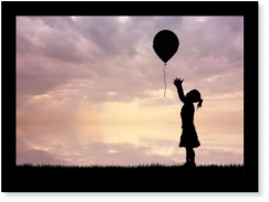 A girl releasing a balloon